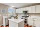 Bright kitchen with white cabinets, stainless steel appliances, and a center island at 20293 E Progress Pl, Centennial, CO 80015