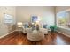 Cozy living room featuring hardwood floors, neutral paint, comfortable seating, and lots of natural light at 20293 E Progress Pl, Centennial, CO 80015