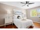 Serene main bedroom featuring a queen-size bed, ceiling fan, and a large window at 20293 E Progress Pl, Centennial, CO 80015