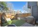 Landscaped backyard with artificial turf, a privacy fence, and outdoor seating at 5415 S Delaware St, Littleton, CO 80120
