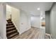 Finished basement with carpeted stairs, neutral paint, and faux wood flooring at 5415 S Delaware St, Littleton, CO 80120