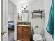 Bathroom with cherry vanity, neutral decor, and an adjoining bedroom at 5415 S Delaware St, Littleton, CO 80120