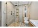 Stylish bathroom features glass enclosed shower with unique tile and wood paneling at 5415 S Delaware St, Littleton, CO 80120