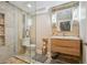Modern bathroom featuring a glass shower, wood accents, and a stylish vanity with updated fixtures at 5415 S Delaware St, Littleton, CO 80120