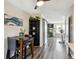Bright open-concept dining area connects kitchen and living room, enhanced by sliding barn doors and modern flooring at 5415 S Delaware St, Littleton, CO 80120