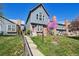 Attractive home featuring well-maintained landscaping, a brick facade, and a bright red door at 5415 S Delaware St, Littleton, CO 80120
