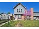 Charming two-story home with brick accents, a well-maintained lawn, and a lovely pink flowering tree at 5415 S Delaware St, Littleton, CO 80120