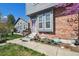 Charming home with a brick facade, front yard garden, and well-maintained walkway at 5415 S Delaware St, Littleton, CO 80120