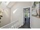 Upstairs hallway featuring skylight that leads into carpeted bedrooms at 5415 S Delaware St, Littleton, CO 80120