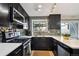 Updated kitchen features mosaic backsplash, stainless appliances, and bright window view at 5415 S Delaware St, Littleton, CO 80120