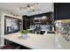 Modern kitchen boasts stainless steel appliances, mosaic backsplash, and quartz countertops at 5415 S Delaware St, Littleton, CO 80120