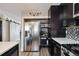 Well-equipped kitchen with stainless steel refrigerator and dark cabinetry at 5415 S Delaware St, Littleton, CO 80120