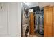 Convenient laundry area with stacked washer and dryer, utility closet, and a water heater at 5415 S Delaware St, Littleton, CO 80120
