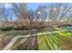 Sunny backyard with mature trees and a paved pathway at 655 S Alton Way # 4B, Denver, CO 80247