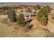 Aerial view of the house nestled among mature trees in a rural, scenic setting at 2619 Mountain View Ave, Franktown, CO 80116