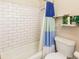 Bright bathroom featuring a shower and tub with modern white subway tile surround at 2619 Mountain View Ave, Franktown, CO 80116
