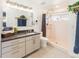 Bright bathroom featuring a walk-in shower, stone countertops, and modern fixtures at 2619 Mountain View Ave, Franktown, CO 80116