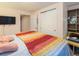 Bright bedroom with an open closet and neutral colors at 2619 Mountain View Ave, Franktown, CO 80116