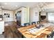 Dining room leading to the kitchen with modern stainless-steel appliances and bright white cabinetry at 2619 Mountain View Ave, Franktown, CO 80116