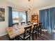 Bright dining room with statement lighting, and beautiful natural light from a large window at 2619 Mountain View Ave, Franktown, CO 80116
