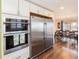 Eat-in kitchen featuring stainless appliances, double oven and adjacent dining area at 2619 Mountain View Ave, Franktown, CO 80116