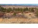 Majestic mountain views extend across a serene landscape, featuring rolling hills and native vegetation at 2619 Mountain View Ave, Franktown, CO 80116