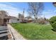 Spacious backyard with lush lawn, garden area, and fenced perimeter at 2565 Gray St, Edgewater, CO 80214