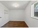 Bedroom featuring wood flooring, a built-in nook, and a window at 2565 Gray St, Edgewater, CO 80214