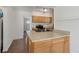 Kitchen featuring a sink island, modern appliances and light wood cabinetry at 2565 Gray St, Edgewater, CO 80214