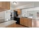 Kitchen featuring modern appliances and light wood cabinetry at 2565 Gray St, Edgewater, CO 80214