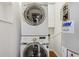 Laundry area featuring stacked washer and dryer at 2565 Gray St, Edgewater, CO 80214