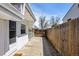 Spacious side yard with concrete path and a privacy fence at 2565 Gray St, Edgewater, CO 80214