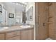 Well-lit bathroom with double sinks and a walk-in shower with grab bars at 479 Black Feather Loop # 311, Castle Rock, CO 80104