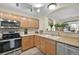 Bright kitchen featuring stainless steel appliances, tile flooring, and seamless access to the dining and living areas at 479 Black Feather Loop # 311, Castle Rock, CO 80104