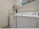 Laundry room equipped with a washing machine, dryer, and overhead shelving at 479 Black Feather Loop # 311, Castle Rock, CO 80104
