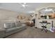 Spacious living room with a comfortable sofa, and an open view to the dining area at 479 Black Feather Loop # 311, Castle Rock, CO 80104