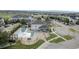 Aerial view of a community pool, clubhouse, manicured green spaces and plenty of parking at 479 Black Feather Loop # 311, Castle Rock, CO 80104