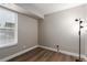 Neutral bedroom with window and modern light fixture at 2575 S Syracuse Way # B101, Denver, CO 80231