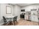 Cozy dining area with a round table and adjacent kitchen featuring stainless steel appliances at 2575 S Syracuse Way # B101, Denver, CO 80231
