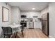 Modern kitchen featuring stainless steel appliances, clean white cabinets, and a dining area at 2575 S Syracuse Way # B101, Denver, CO 80231