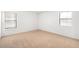 Bright bedroom with neutral carpet and two windows offering ample natural light at 4896 S Dudley St # 6-5, Littleton, CO 80123