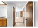Hallway view showing access to the kitchen and the living area with a stone fireplace at 4896 S Dudley St # 6-5, Littleton, CO 80123