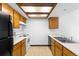 Functional kitchen featuring light wood cabinets, essential appliances, and ample counter space at 4896 S Dudley St # 6-5, Littleton, CO 80123