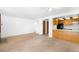 Open concept living room showcasing neutral carpet and access to kitchen and other areas at 4896 S Dudley St # 6-5, Littleton, CO 80123