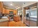 Bright kitchen featuring wood cabinets, stainless steel appliances, and hardwood floors at 6406 Silver Mesa Dr # F, Highlands Ranch, CO 80130