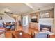 Inviting living room with fireplace, wood floors, and dining area at 6406 Silver Mesa Dr # F, Highlands Ranch, CO 80130