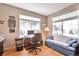 Bright home office features wood floors, large windows, and comfortable seating at 6406 Silver Mesa Dr # F, Highlands Ranch, CO 80130
