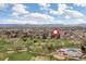 Aerial view of community with a golf course and swimming pool in a neighborhood, with mountain views at 930 Reed Ct, Lakewood, CO 80214