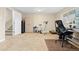 Finished basement area with an exercise bike, office space, and ample room at 930 Reed Ct, Lakewood, CO 80214