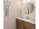 Modern bathroom with granite counters, accent tiles, and decorative mirror at 930 Reed Ct, Lakewood, CO 80214